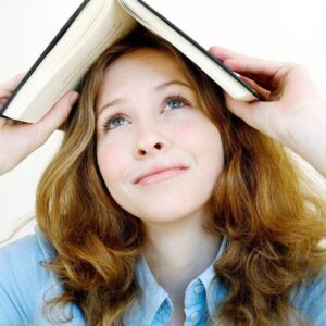 Woman looking and thinking with a book above her head