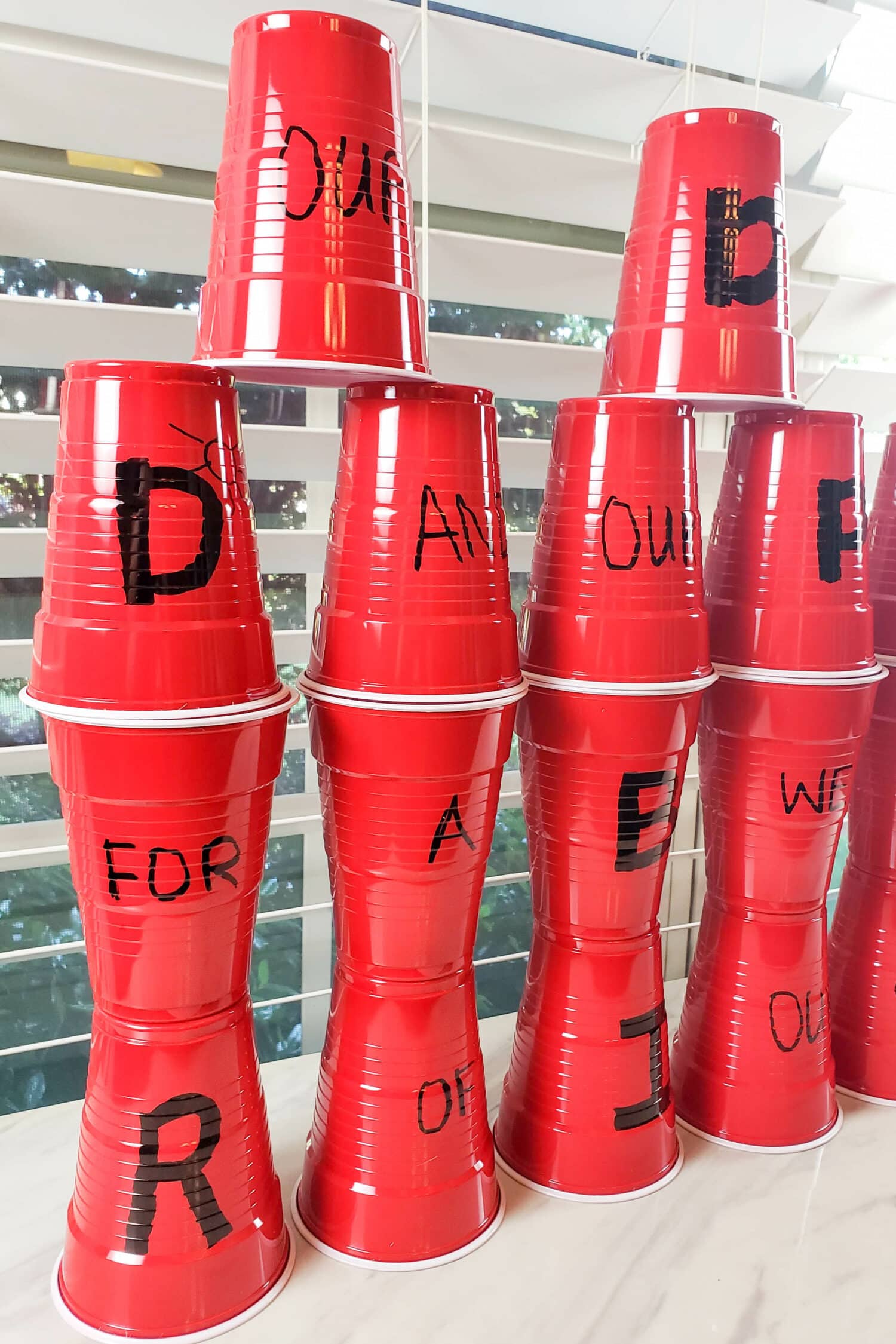 Redeemer of Israel Cup Stacking singing time ideas for LDS Primary Music Leaders. The kids will absolutely love stacking cups in a tall castle wall or pyramid as they learn this beloved Hymn with a crack the code hidden in!