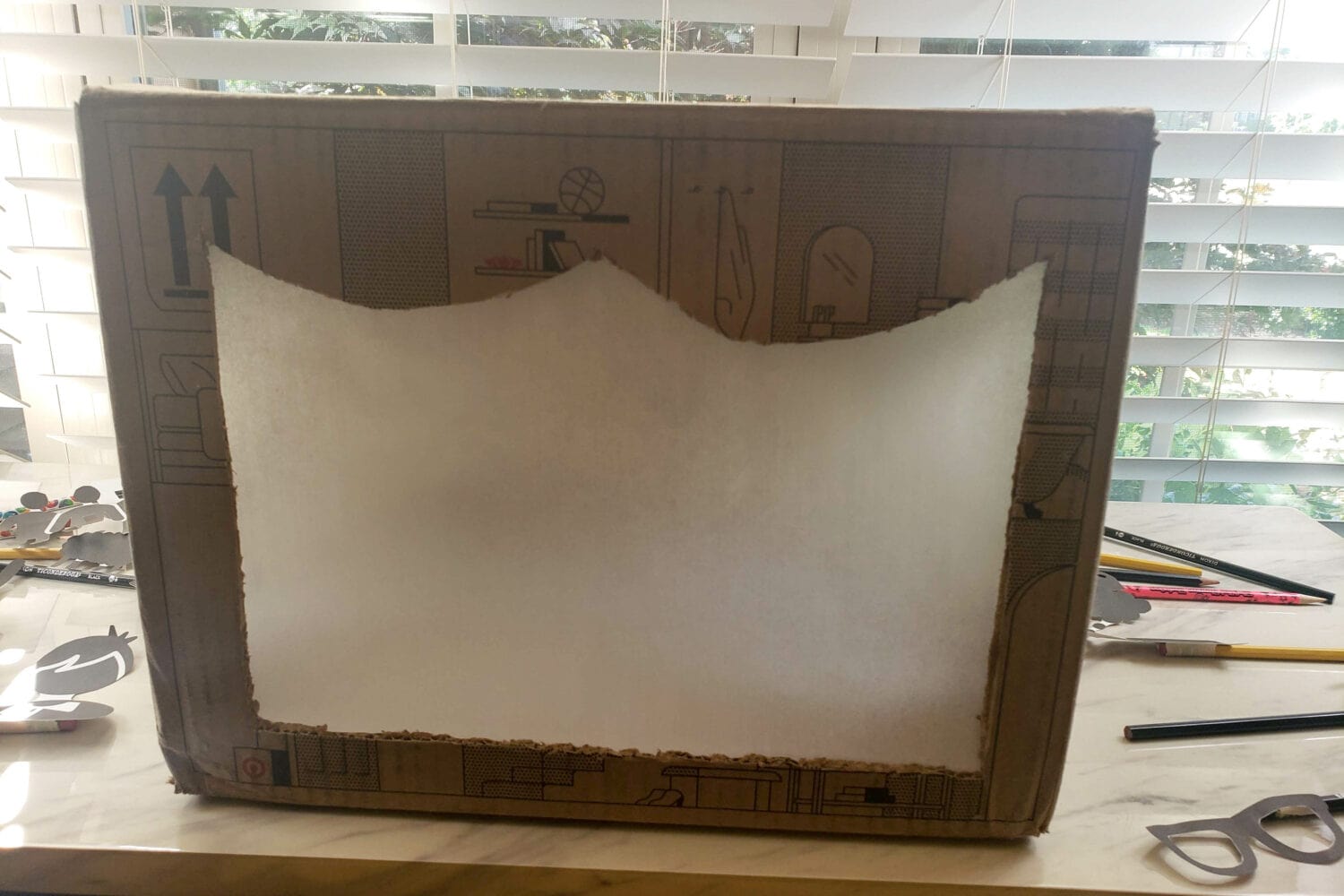 How to Make a Shadow Puppet DIY Tutorial with step-by-step directions to easily make your own shadow puppet theater with what you have around the home! Shadow puppet theater screen cardboard box
