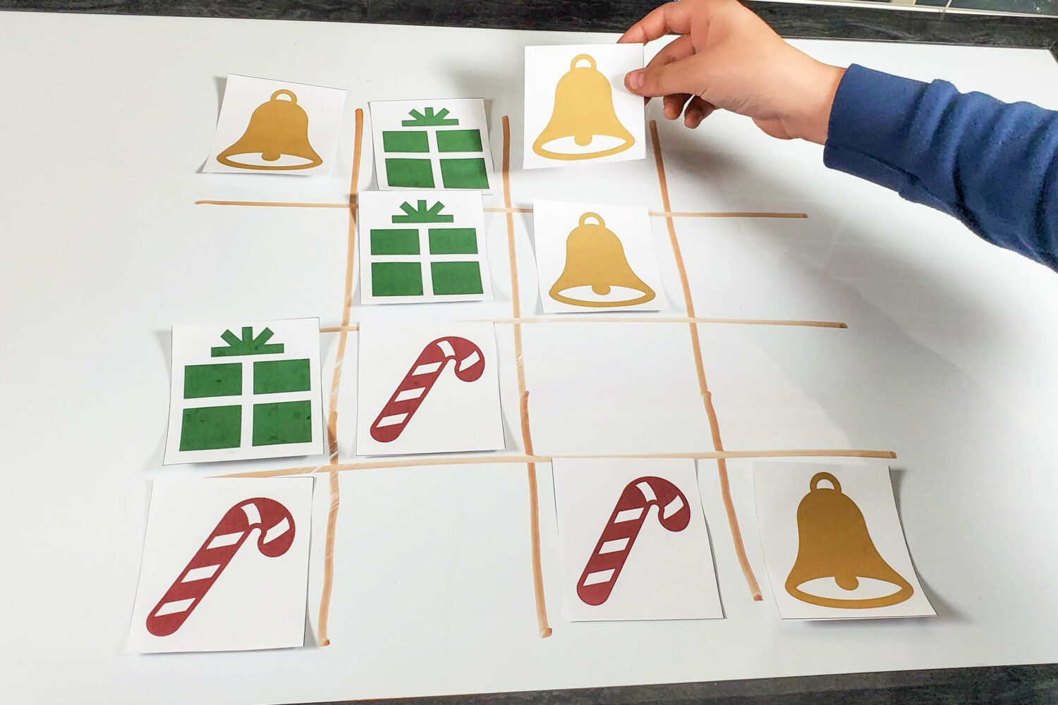 Christmas Tic Tac Toe - A fun 3 player Tic Tac Toe (or 3 teams) with symbols for the shepherds, angels, and wise men and lots of repetition for a single song, mix of songs, or 3 Christmas songs of your choice! Fun singing time idea or printable game for families.