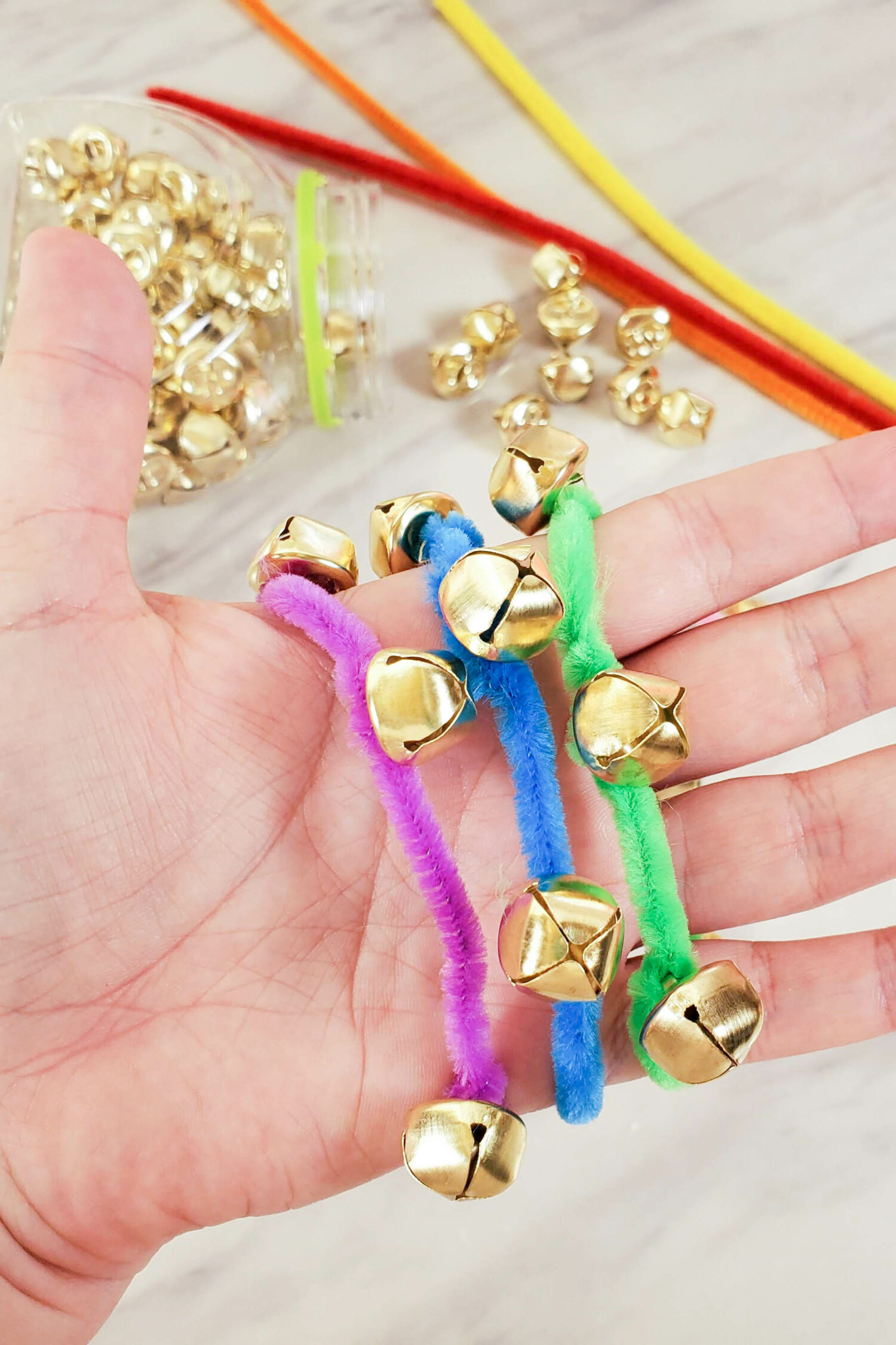 How to Make Jingle Bell Bracelets easy and inexpensive step-by-step tutorial with lots of directions, ideas for using them in singing time, and even a tip on how to hold the wrist bands!! Great ideas for music teachers and LDS Primary Music Leaders or even as a fun at home craft for preschoolers and homeschool children.