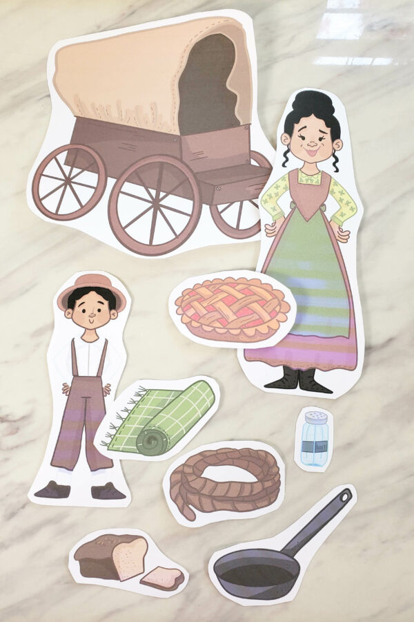Pioneer family cut outs with supplies for a pioneer day singing time game